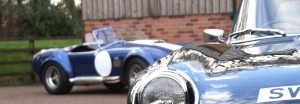 A AC Cobra and a classic Jaguar at Classic Car Storage UK. 